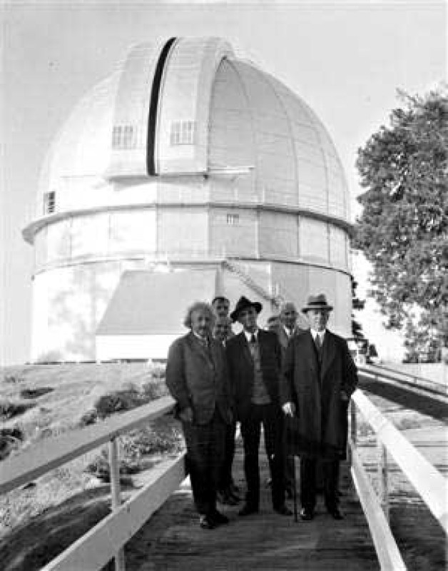 Albert Einstein, Edwin Hubble, Walther Mayer, Walter S. Adams, Arthur S. King, and William W. Campbell standing on the bridge before the 100-inch Hooker Telescope